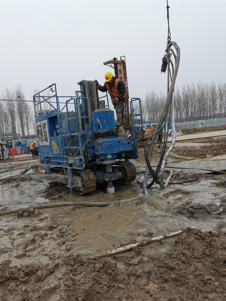 Workers operating SJL-120 rotary jet drill at construction site